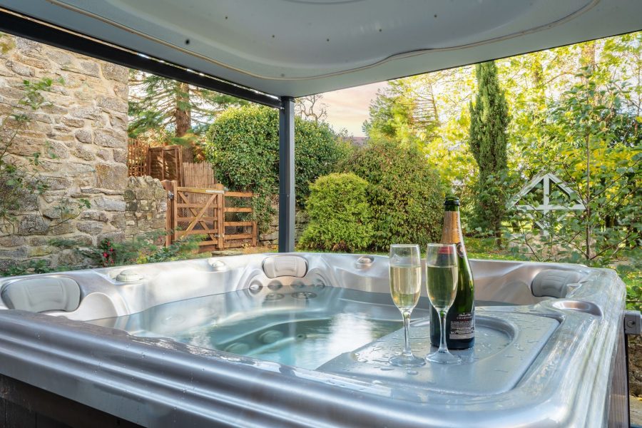 Private, covered hot tub with garden views at Sun Hill Farmhouse.